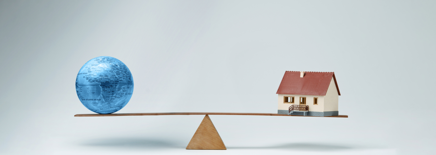 World,Globe,And,Model,House,Balancing,On,A,Seesaw World globe and model house balancing on a seesaw